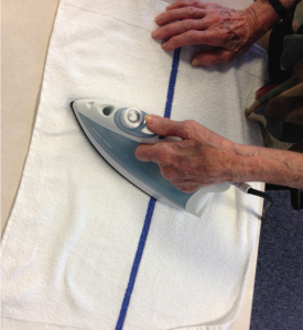 A patient practicing ironing after a broken wrist