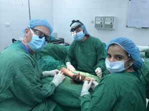 Dr. Moss working with Honduran colleagues to reconstruct a thumb injured in a motorcycle accident.